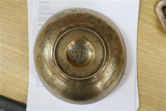 An Islamic bronze magic bowl with incised Koranic inscriptions within geometric motifs, Dia 7.5in (wear to interior)